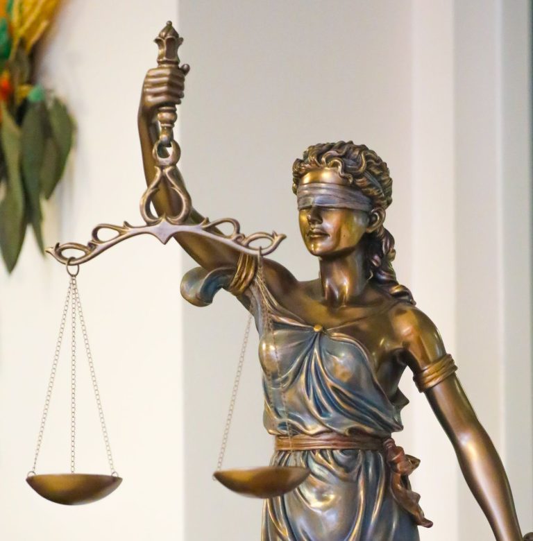 Bronze Lady Justice statue with scales and sword, symbolizing law and fairness, displayed indoors in İstanbul.